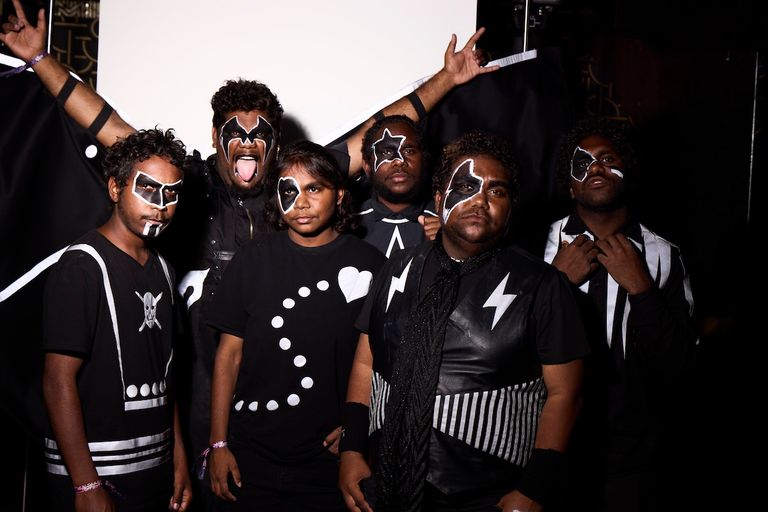 Aboriginal rock band Mulga Bore Hard Rock pose in black-and-white face paint and themed outfits inspired by KISS.